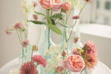 13 simple pink flower arrangement in different bottles and vases