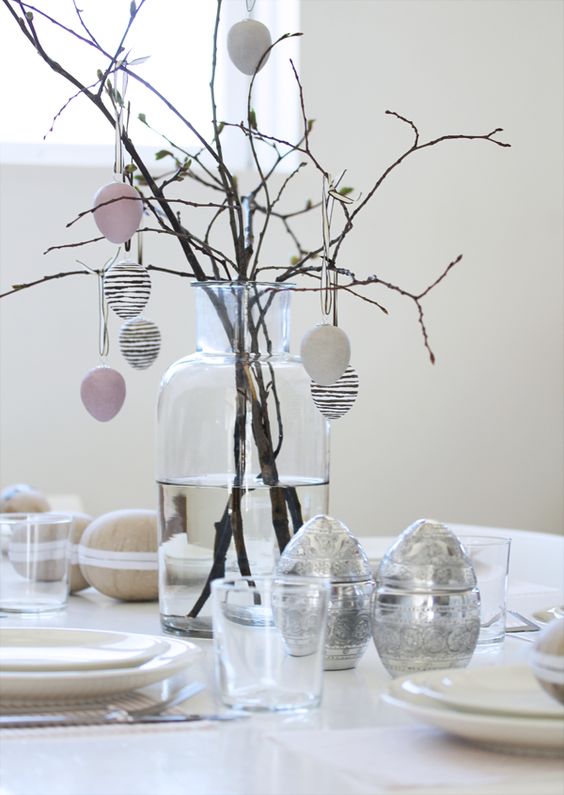 Easter eggs hanging on banches as a holiday centerpiece