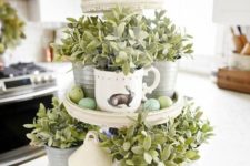 15 a cupcake stand with vintage cups with greenery and speckled eggs