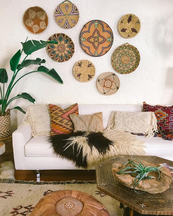 a boho living room is highlighted with bold painted wall baskets