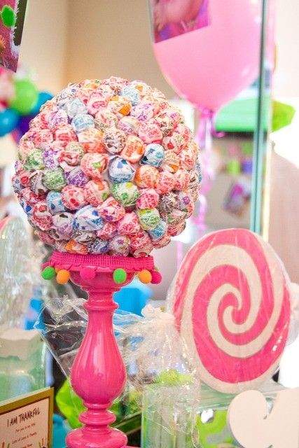 a styrofoam ball with lollipops inserted inside