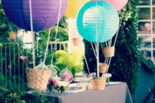 17 colorful hot air balloons as decor for an outdoor baby shower