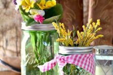 17 green jars with checked fabric and fresh spring blooms