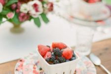 18 place containers with berries on each place setting as a cute trifle