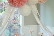 19 paper lanterns and pompoms over the dessert table look sweet