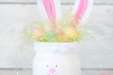 21 a white mason jar turned into a bunny with ears and pompom eggs