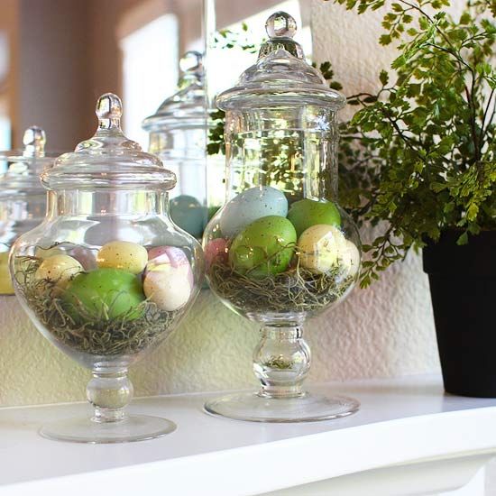 half-dozen faux Easter eggs in pastel colors placed in apothecary jars and lined with straw
