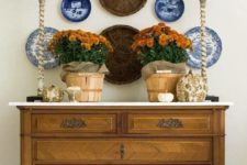 21 wall baskets are combined with blue and white plates for a rustic feel