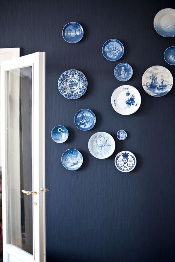 a beautiful blue plate wall is a gorgeous decoration for many spaces, these chic plates add interest to the plain wall