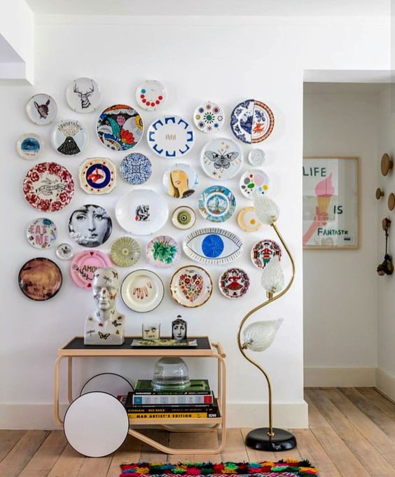 a bright and quirky plate wall with colorful plates creating an eclectic look that makes the space cooler