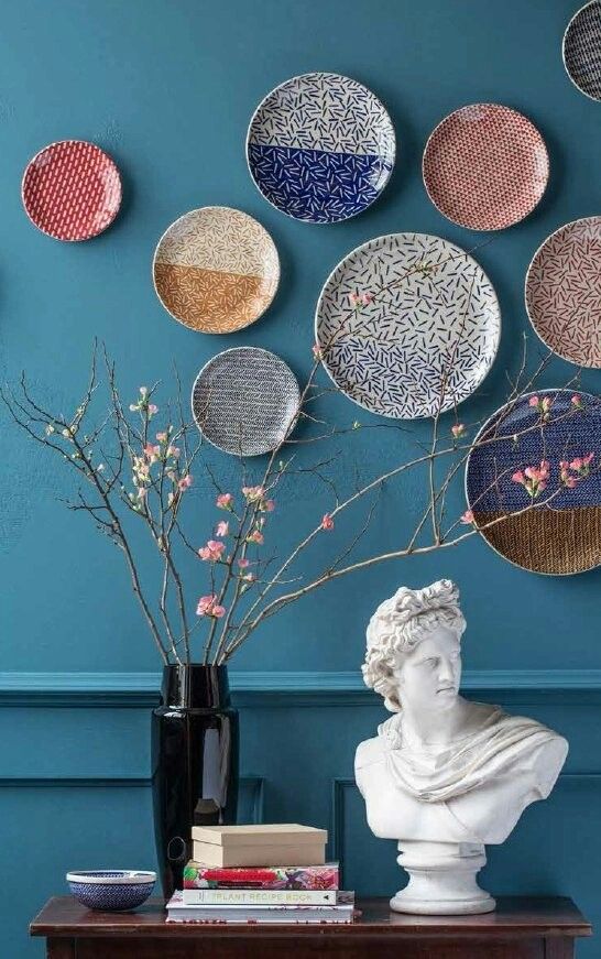 a colorful plate wall with various patters is a lovely decoration for any space, it looks lovely and cool
