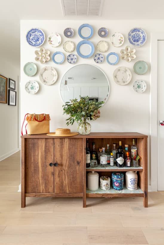a lovely plate wall with mismatching chinoiserie and vintage plates is a cool decoration for any space