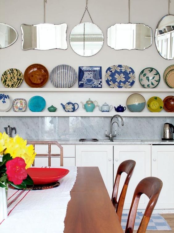 a plate wall created using open kitchen shelves is a lovely way to display your beautiful plates and add color and interest to the kitchen