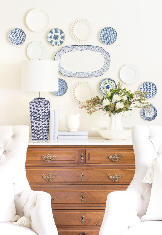 a plate wall of white and chinoiserie plates is a lovely decoration for a coastal farmhouse space