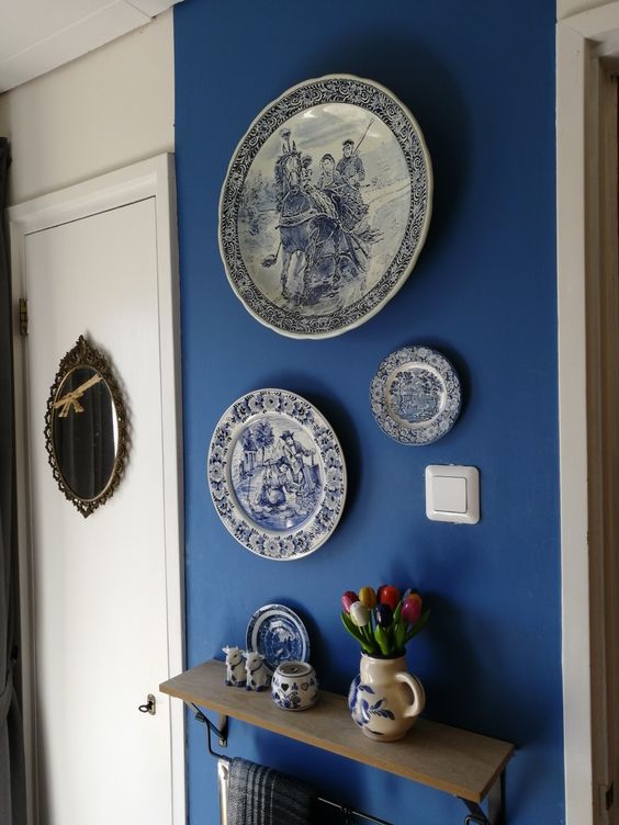 an indigo wall with chinoiserie plates is a cool solution for many vintage spaces, they bring interest to the blank and bold wall