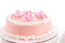 DIY pink baby shower cake with piglets and elephants