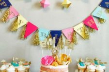 02 a geometric garland and dimensional geo hangers over the dessert table