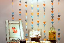 colorful triangle garlands as a dessert table backdrop