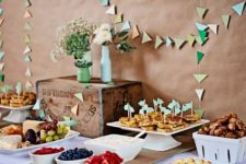 04 colorful triangle garlands over the dessert table for a vintage shower