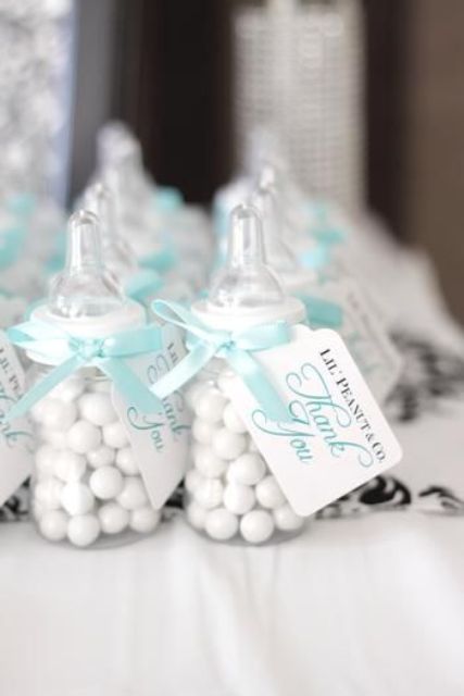 candy favors in baby's bottles with turquoise ribbons