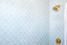 05 light blue fish scale tiles create a calming impression and gold fixtures add interest