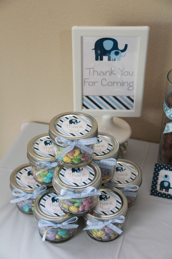 candy favors in jars with elephant tags for an elephant-theme baby shower