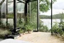 07 a small metal and glass house placed on a lake shore to enjoy the views