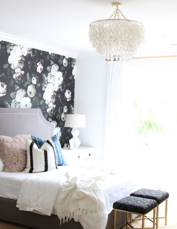 a single dark floral wall in a light-filled and cute bedroom is a show-stopper