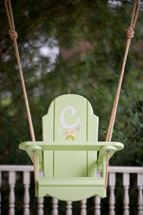 little pastel green wooden swing with a monogram for a little girl