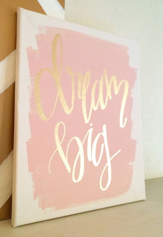 a quote canvas in gold and pink is cute for a glam nursery