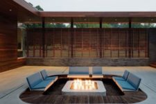 13 a modern conversation pit with a fire in the center and attached seats