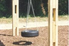 13 a tire hung on chains on a wooden arch is a cool rustic solution