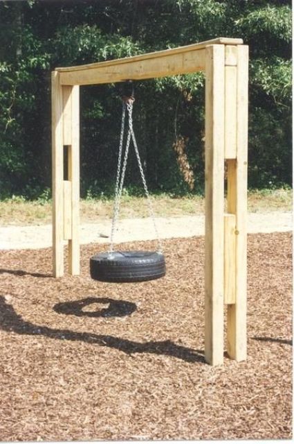 a tire hung on chains on a wooden arch is a cool rustic solution