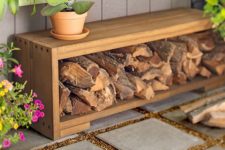 13 outdoor bench with an open storage space and firewood inside