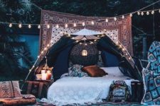 14 an outdoor bed covered with a tent to avoid rain