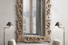 15 a mirror in a carved wooden frame with vignettes