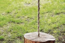 15 a simple swing of a wooden slice and rope for standing or sitting