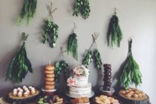 15 bunches of greenery over the dessert table look chic for a boho shower