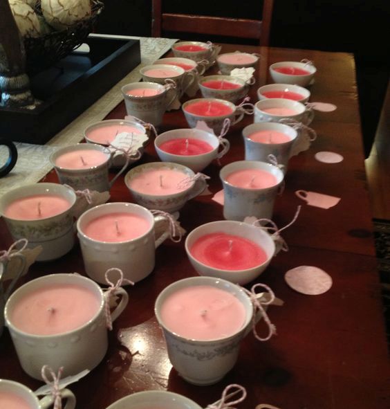 pink and fuchsia candles in cups for a girl's baby shower