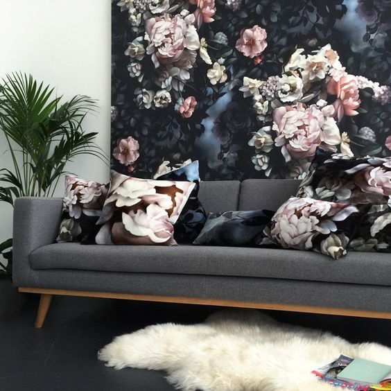 a moody floral wall and matching pillows to tie the look up