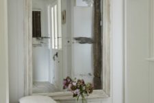 17 an oversized mirror in a whitewashed frame for a Scandinavian entrance