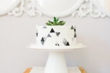 18 a simple modern cake with grey geo decor and a succulent