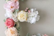 19 letter art piece made of faux flowers is the cutest idea for a girlish space