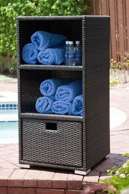 wicker cabinet with a drawer and towel storage for a pool area