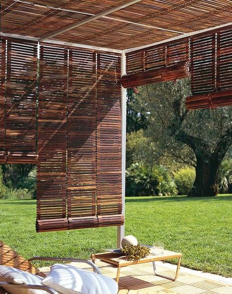 a pergola completely covered with wooden shutters to keep it more private and to protect people from excessive sunshine