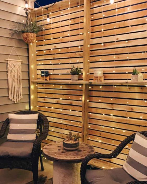 a stained privacy screen with lights, a shelf with potted plants are a lovely idea for a modern terrace or porch