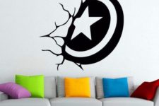 02 a black and white wall decal that looks like a Captain America shield stuck in the wall