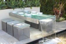 04 a built-in outdoor table with a waterfall design and metal stools