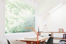 mid-century modern office with a panorama window and forest views