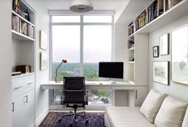 small minimalist home office in white with a glazed wall and a view on the town